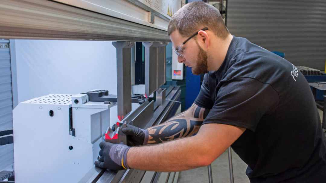 Man doing manufacturing quality checks with machinery