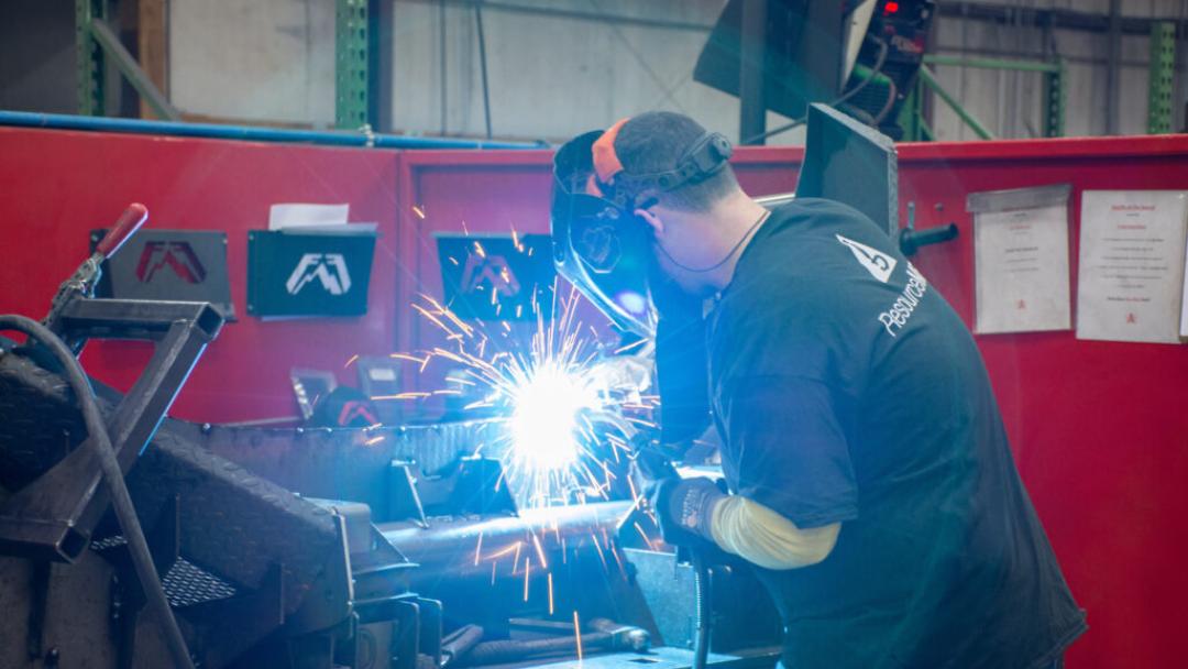 A welder welding with a mask