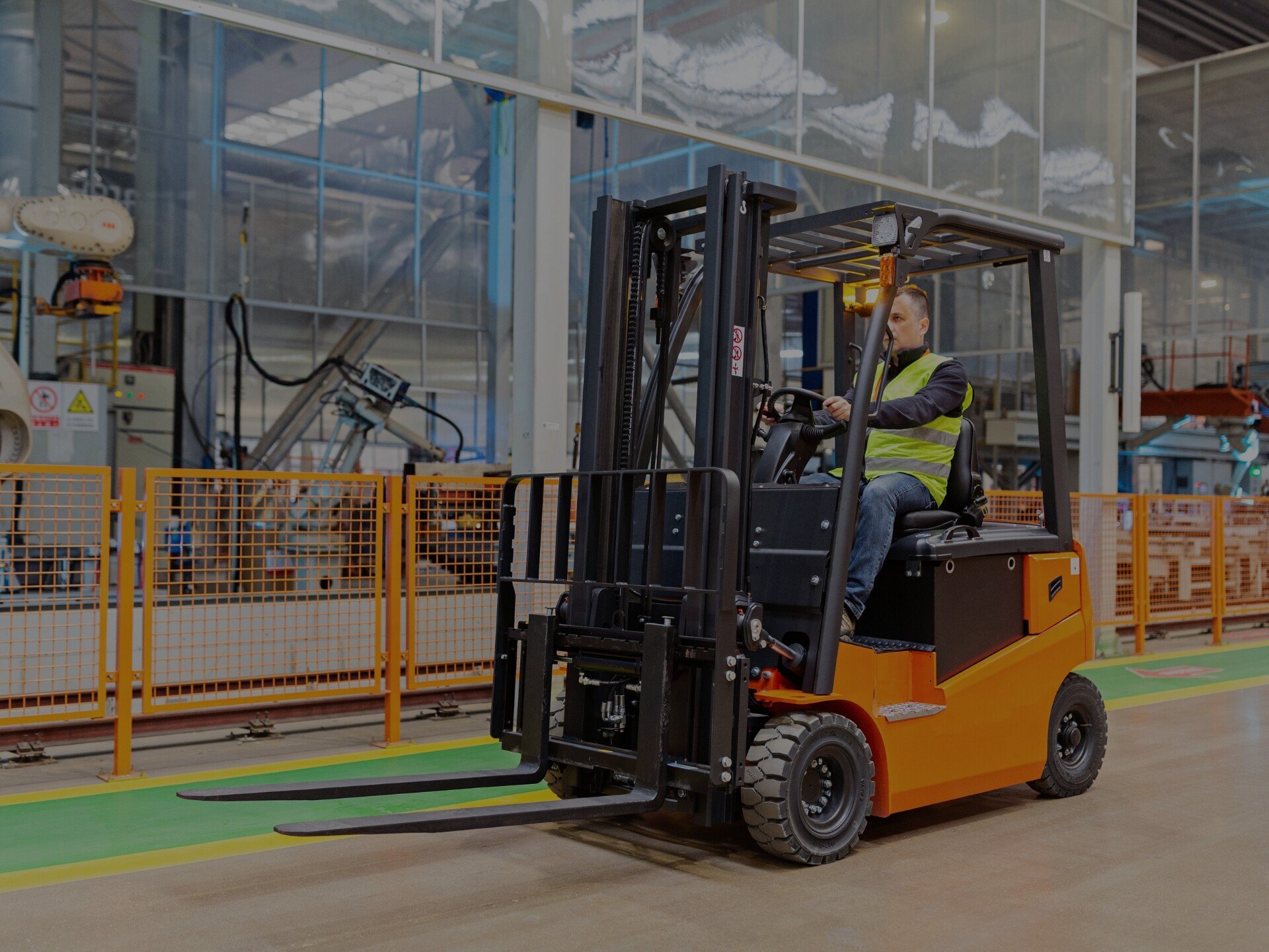 Forklift operator using a orange forklift machine.