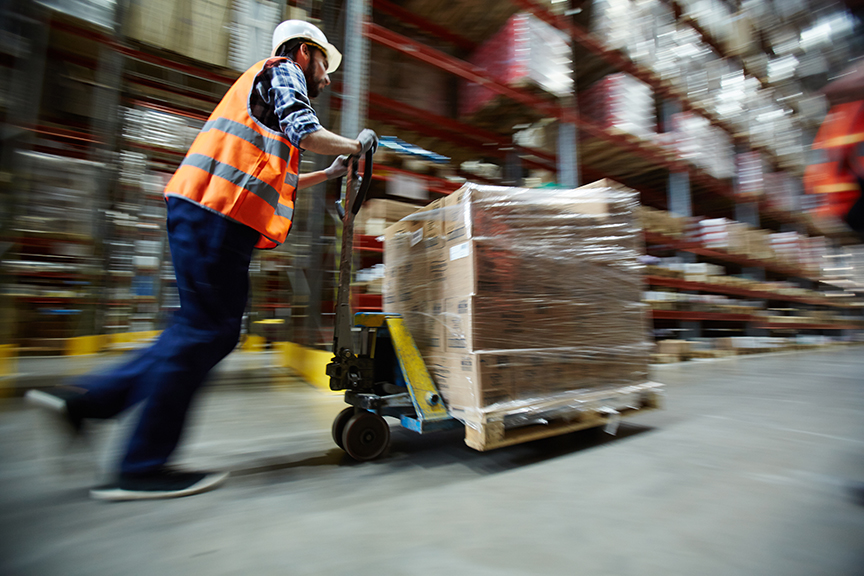 warehouse worker pushing pallet jack showing optimize workforce productivity